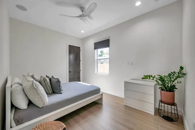 a bedroom with a bed and a potted plant