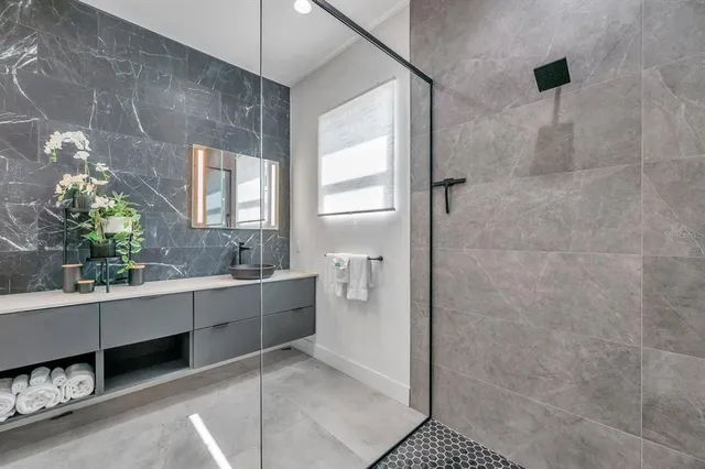 a bathroom with a tub sink and mirror