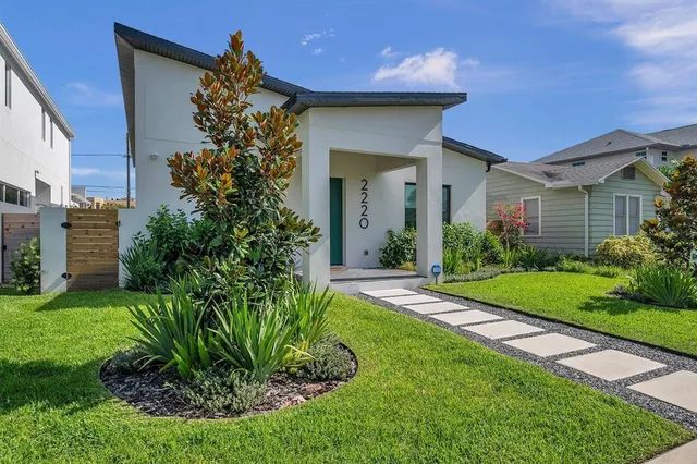 a view of a house with a yard and plants