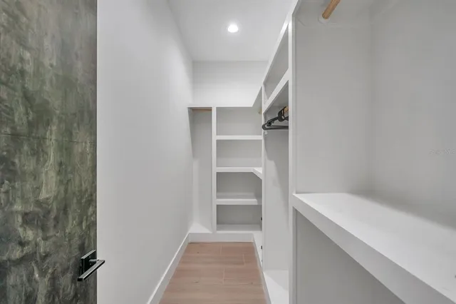 a hallway view with staircase