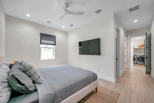 a bedroom with a bed and a flat screen tv