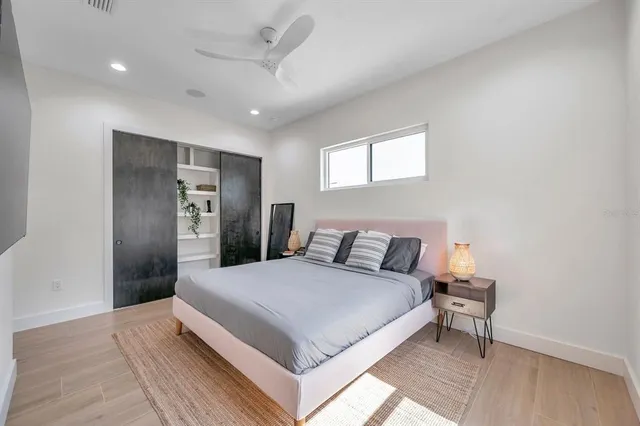 a bedroom with a large bed and a chandelier