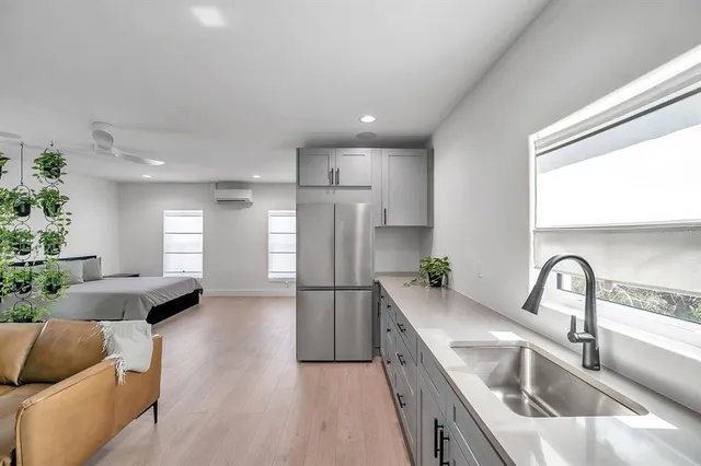 a kitchen with white cabinets and stainless steel appliances