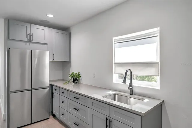 a kitchen with refrigerator a sink and cabinets