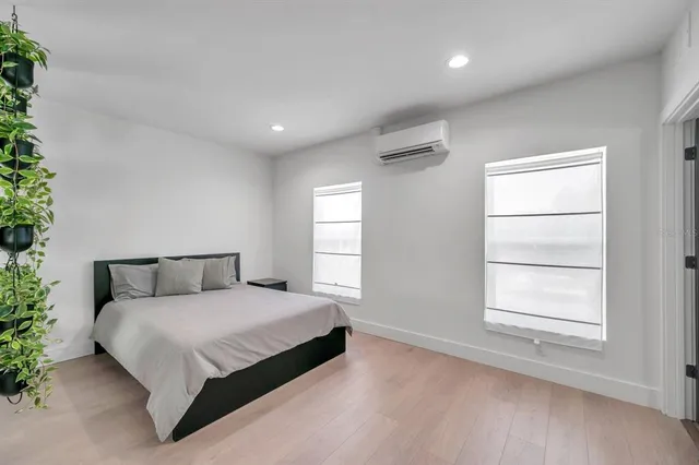 a bedroom with a large bed and a window