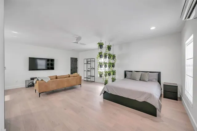 a spacious bedroom with a bed and a couch