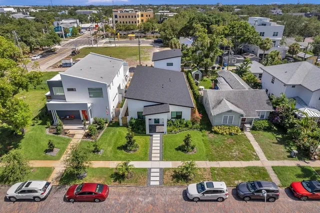an aerial view of houses with yard