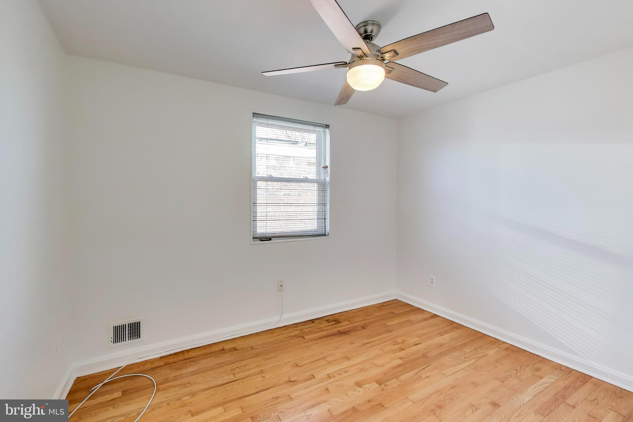 5864 Eastern Avenue Northeast Washington, DC 20011 - Photo 16 of 30 an empty room with windows and fan