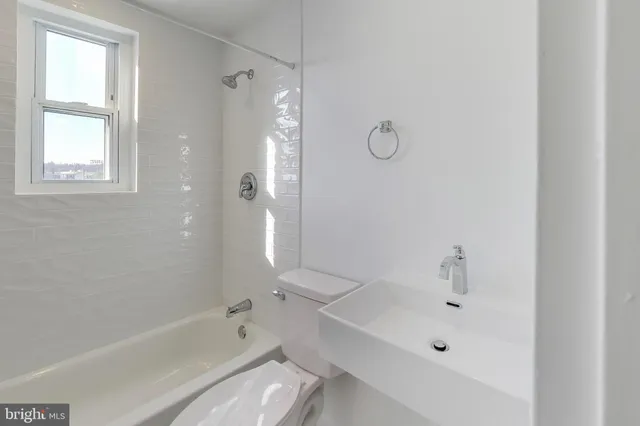 a bathroom with a tub sink vanity and a mirror