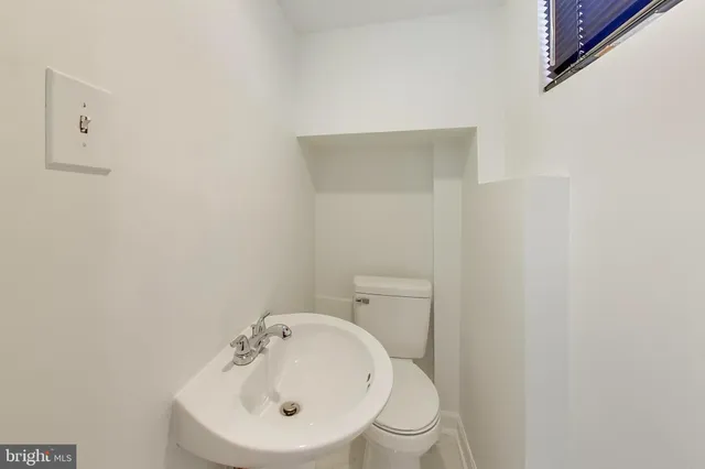 a white toilet sitting next to a white sink