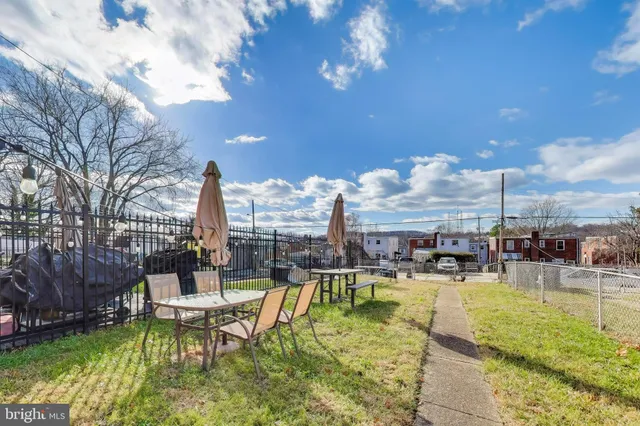 a swimming pool view with a outdoor seating and a garden