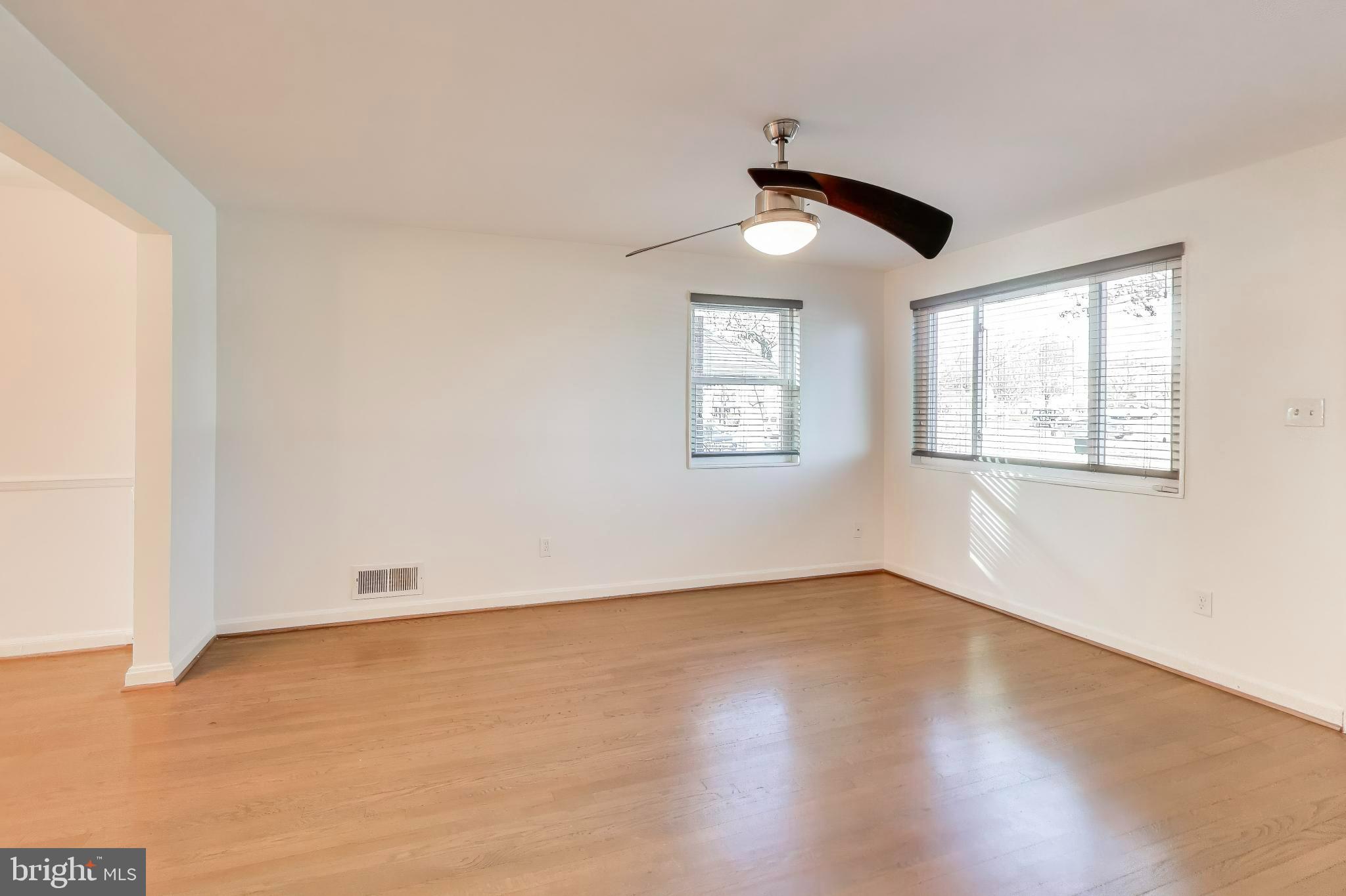 5864 Eastern Avenue Northeast Washington, DC 20011 - Photo 5 of 30 a view of an empty room with wooden floor and a window