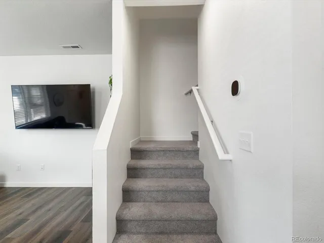 a view of entryway and hall with wooden floor