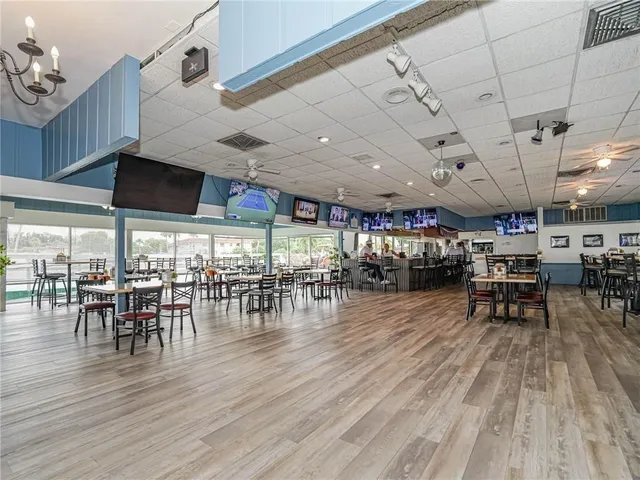 a view of a room with lots of furniture and wooden floor