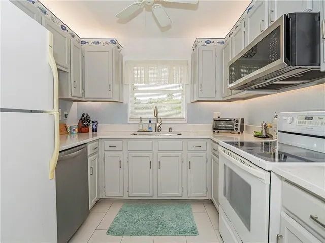 a kitchen with appliances cabinets and a sink
