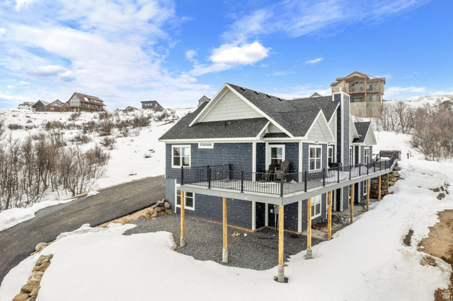1343 North Trapper Loop Garden City, UT 84028 - Photo 54 of 56 Snow covered back of property featuring a deck and roof with shingles