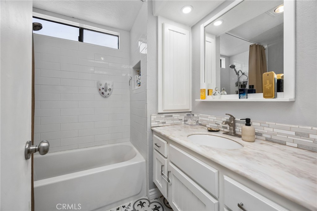 15251 Leffingwell Road, Unit 8 Whittier, CA 90604 - Photo 16 of 30 a bathroom with a tub sink and mirror