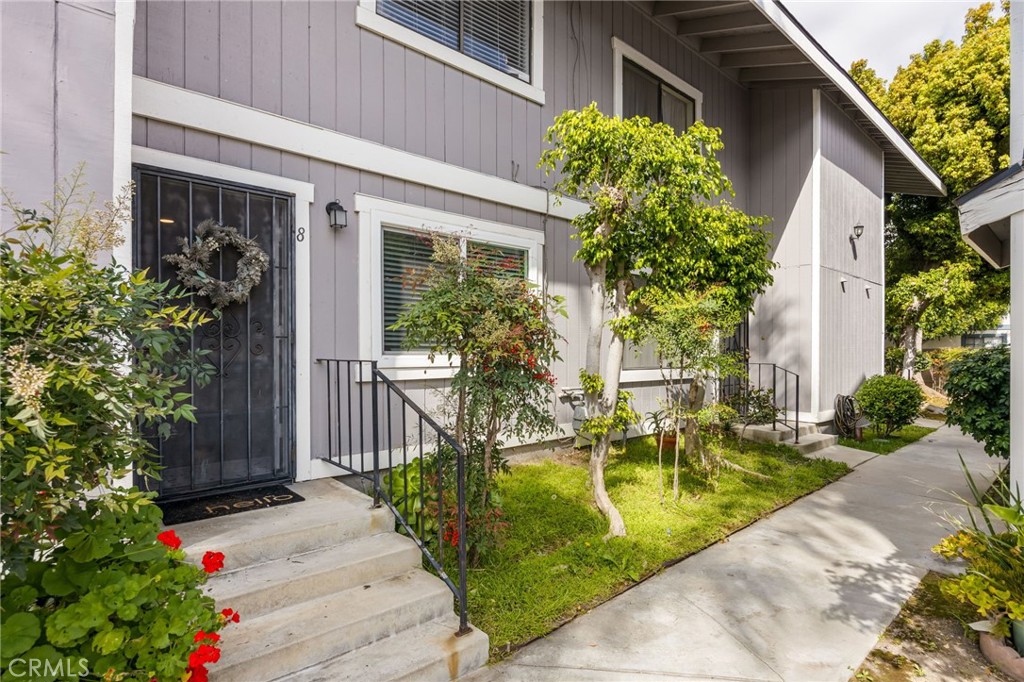 15251 Leffingwell Road, Unit 8 Whittier, CA 90604 - Photo 2 of 30 a front view of house and yard with beautiful flowers