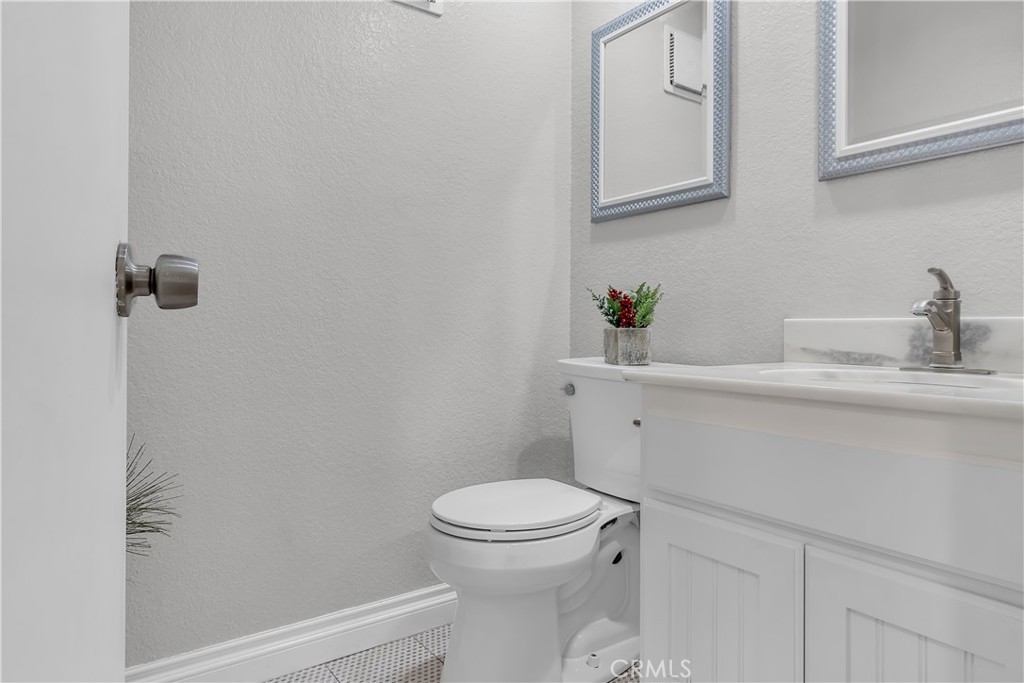 15251 Leffingwell Road, Unit 8 Whittier, CA 90604 - Photo 4 of 26 a bathroom with a sink a toilet and a mirror