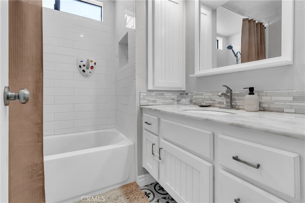 15251 Leffingwell Road, Unit 8 Whittier, CA 90604 - Photo 8 of 26 a bathroom with a tub sink and mirror
