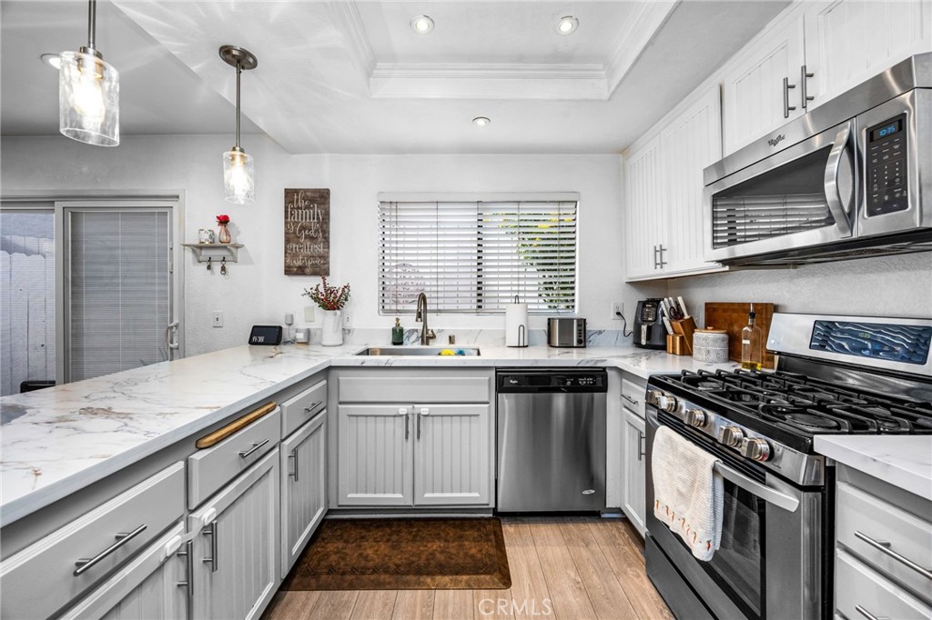 15251 Leffingwell Road, Unit 8 Whittier, CA 90604 - Photo 9 of 30 a kitchen with stainless steel appliances a sink stove and cabinets