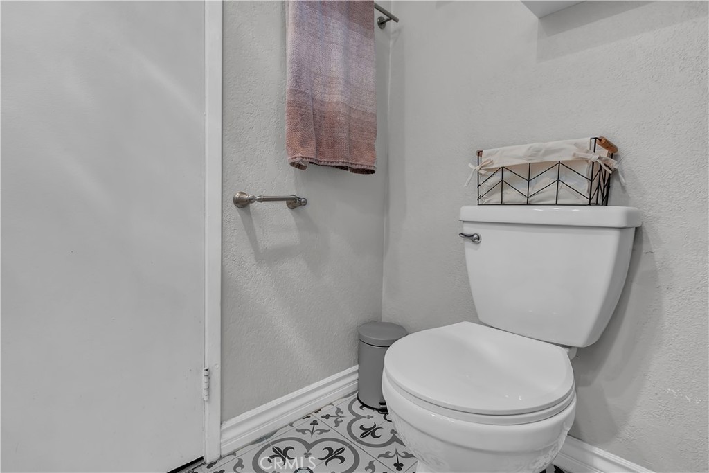 15251 Leffingwell Road, Unit 8 Whittier, CA 90604 - Photo 9 of 26 a white toilet sitting next to a shower curtain