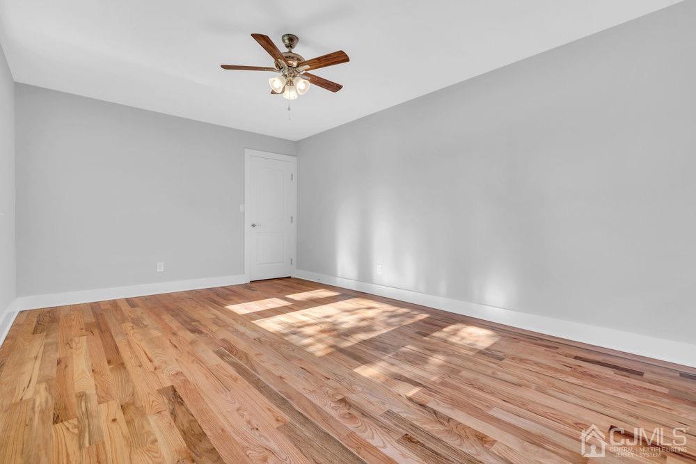 7 Bruning Road East Brunswick, NJ 08816 - Photo 4 of 20 a view of a room with wooden floor and a ceiling fan