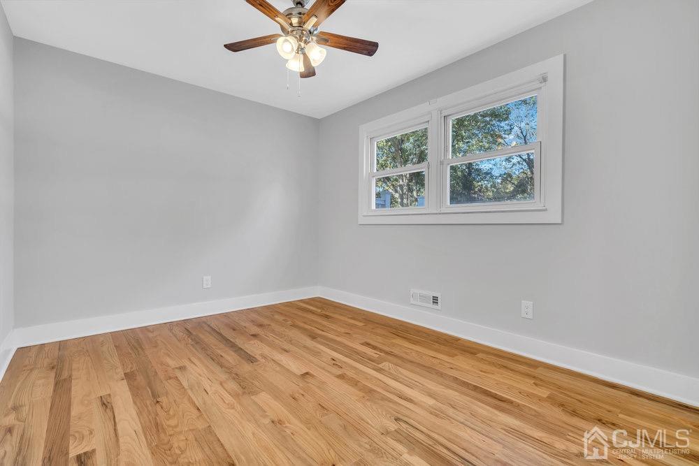 7 Bruning Road East Brunswick, NJ 08816 - Photo 7 of 20 a view of a big room with wooden floor and windows