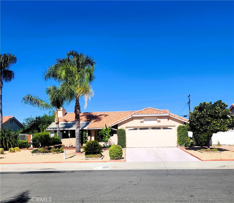 26592 Braddock Road Menifee, CA 92586 - Photo 1 of 23 a front view of a house with a yard and garage