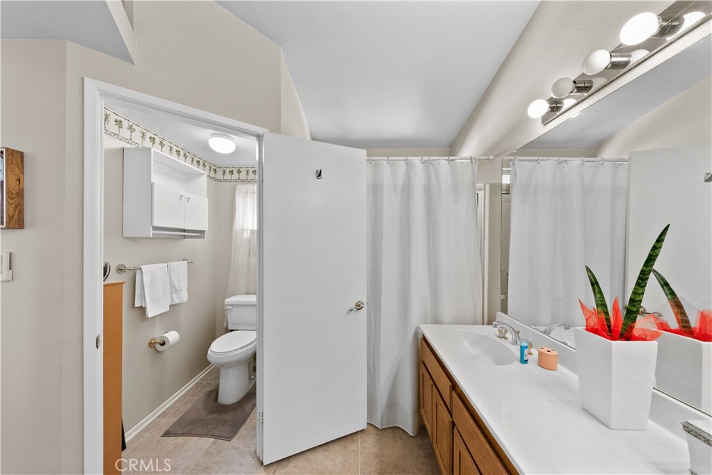 26592 Braddock Road Menifee, CA 92586 - Photo 13 of 23 a bathroom with a double vanity sink toilet and shower