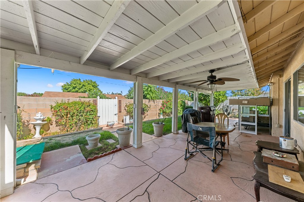 26592 Braddock Road Menifee, CA 92586 - Photo 20 of 23 a view of a patio with table and chairs potted plants with floor to ceiling window