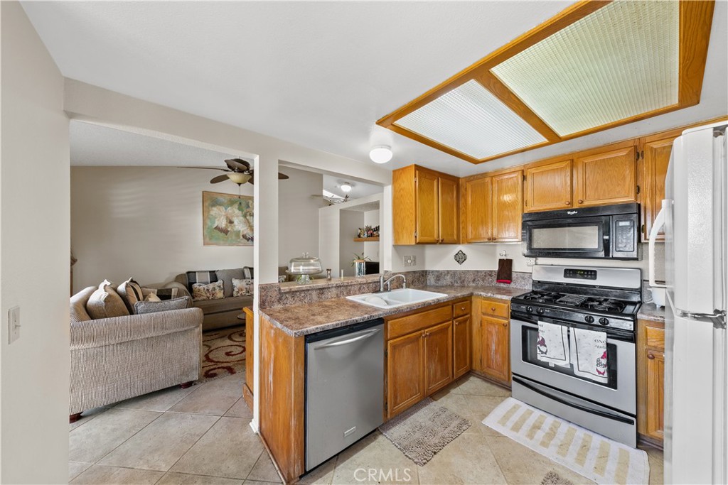 26592 Braddock Road Menifee, CA 92586 - Photo 8 of 23 a kitchen with a stove a sink and a refrigerator