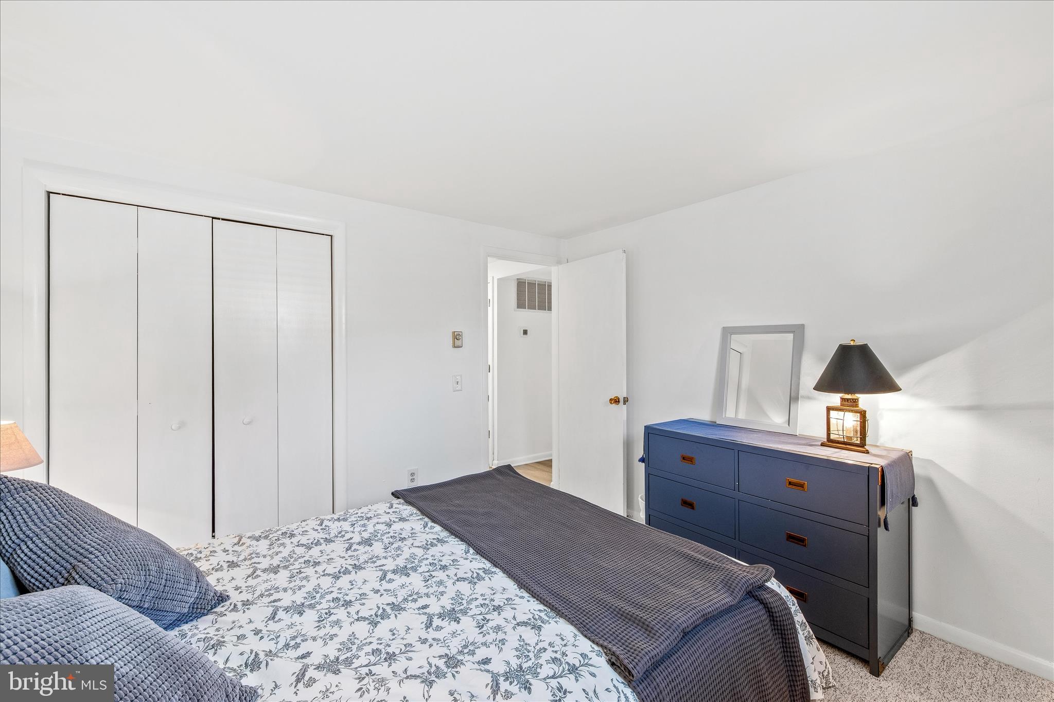 21406 Dogwood Cove Road Tilghman, MD 21671 - Photo 34 of 68 a bedroom with a bed and a dresser