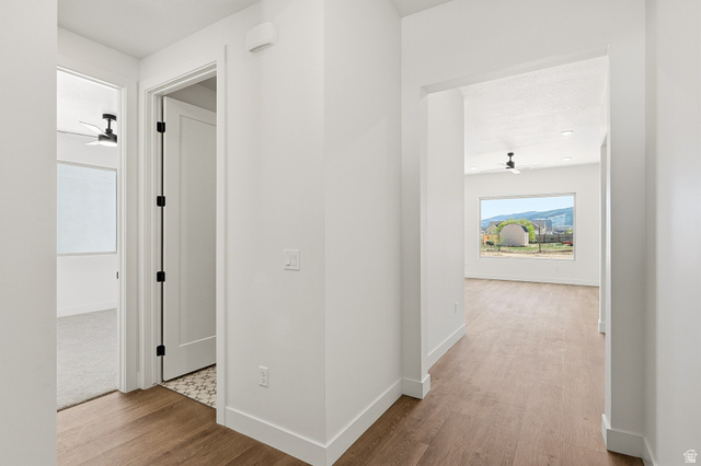 4978 North 75 East Enoch, UT 84721 - Photo 3 of 60 Hallway with light wood-type flooring and baseboards