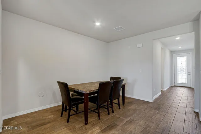 a large kitchen with cabinets table and chairs
