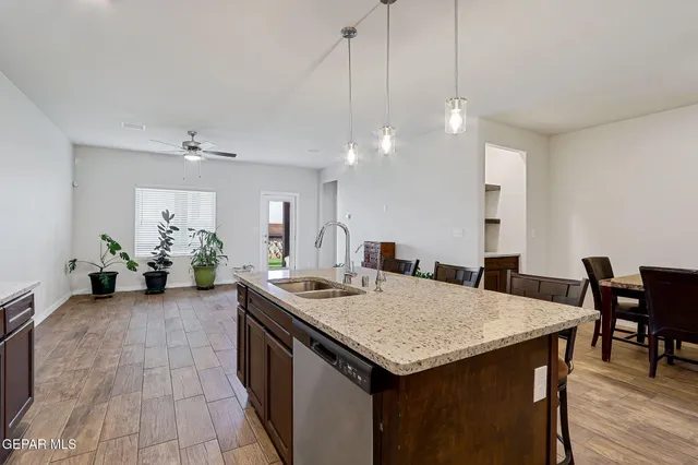 a kitchen with kitchen island a sink stove and refrigerator
