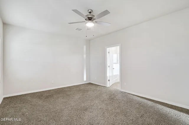 a bathroom with double vanity and a mirror