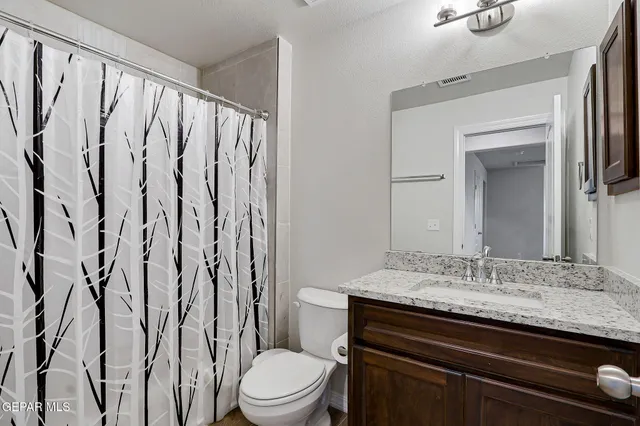 a bedroom with bed and a chandelier