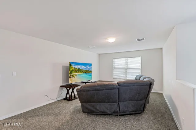 a view of a porch with furniture and garden