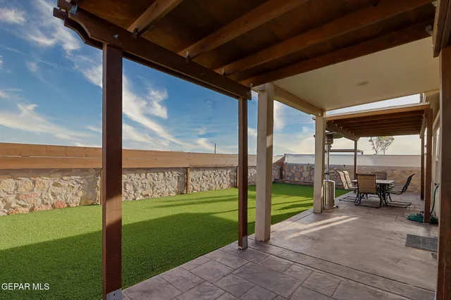a view of a house with a backyard porch and sitting area