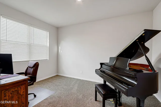 a view of an entryway with wooden floor and a kitchen