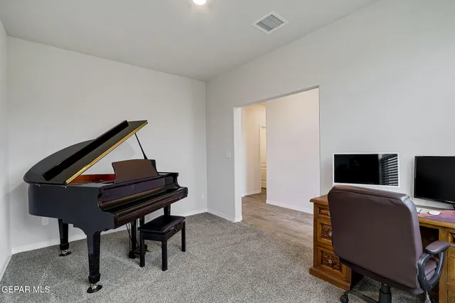 a bathroom with a granite countertop sink toilet and mirror