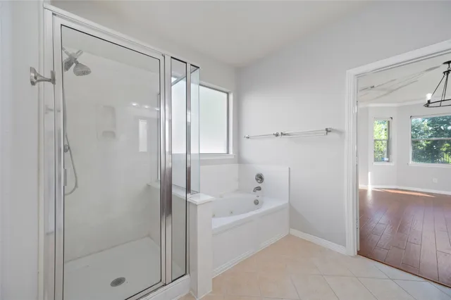 a bathroom with a bathtub shower and toilet
