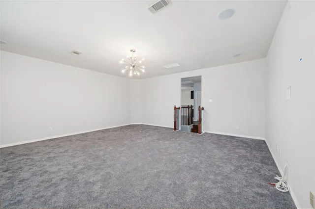 a view of empty room with a chandelier