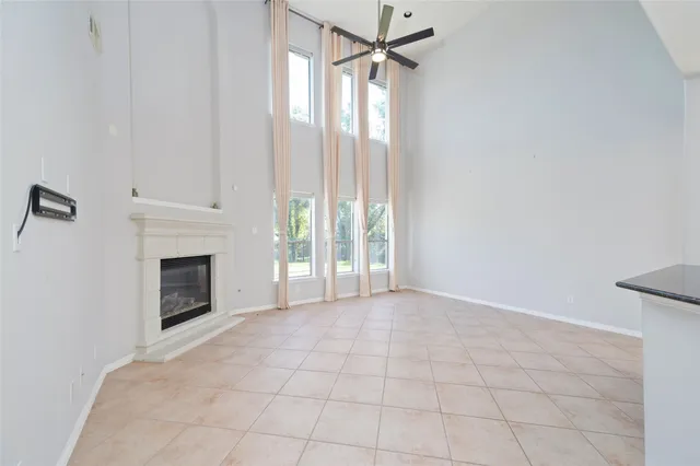 a view of an empty room with a fireplace and a window