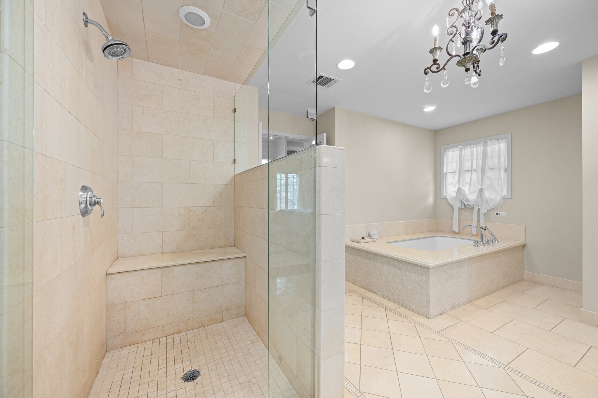 3100 Pecos Street Austin, TX 78703 - Photo 23 of 38 a bathroom with a tub sink a shower and a mirror