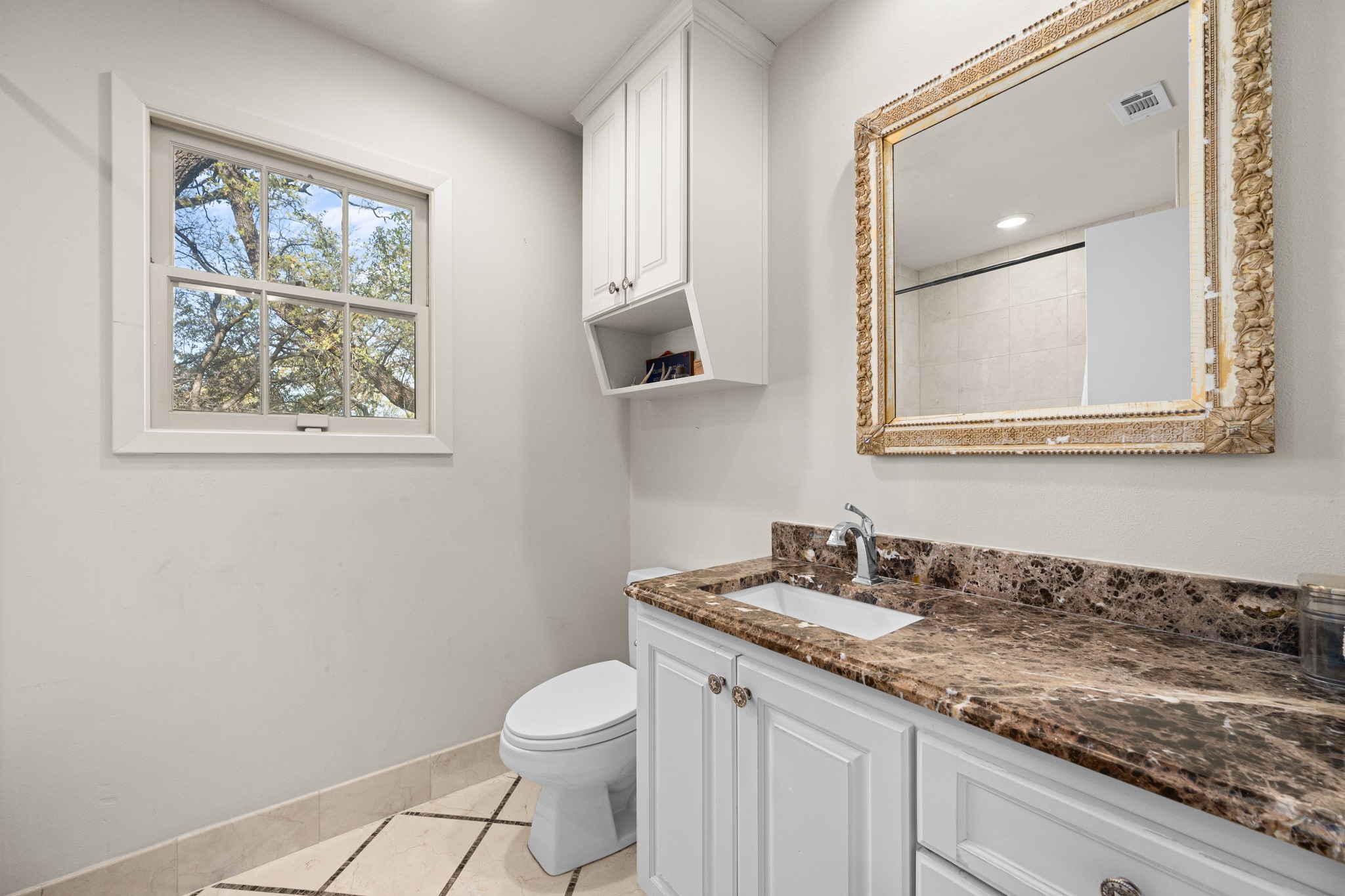 3100 Pecos Street Austin, TX 78703 - Photo 31 of 38 a bathroom with a granite countertop toilet sink and mirror