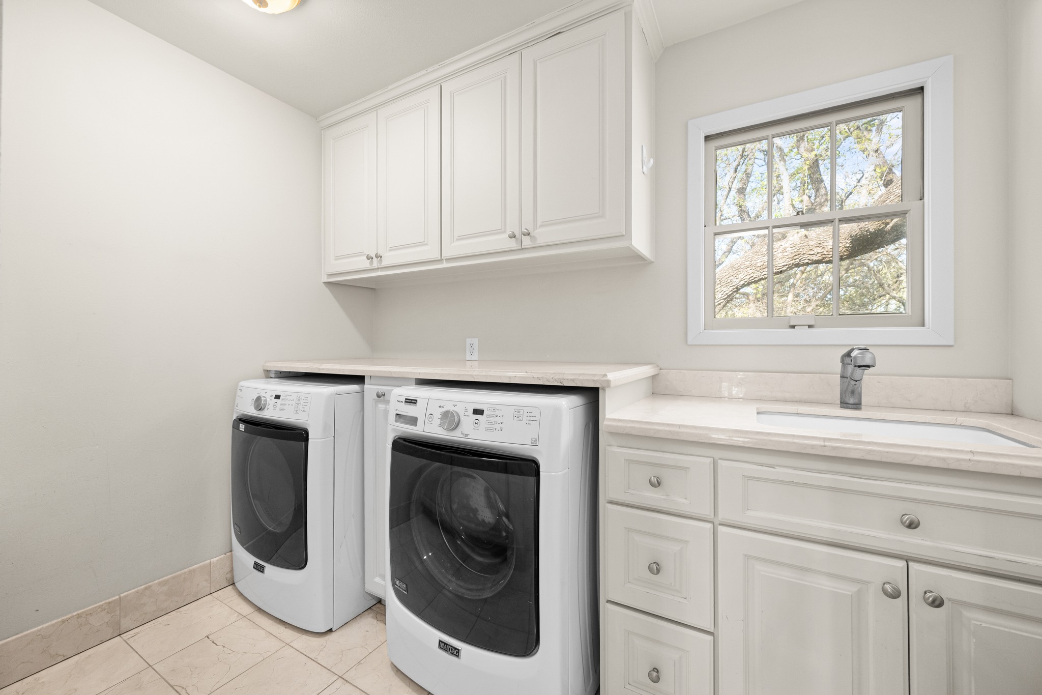 3100 Pecos Street Austin, TX 78703 - Photo 34 of 38 a utility room with sink dryer and washer