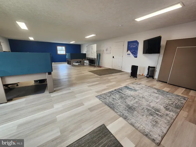a view of kitchen with stainless steel appliances kitchen island sink refrigerator and stove