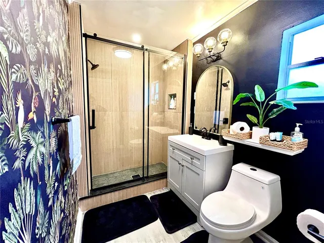 a bathroom with a sink toilet and shower
